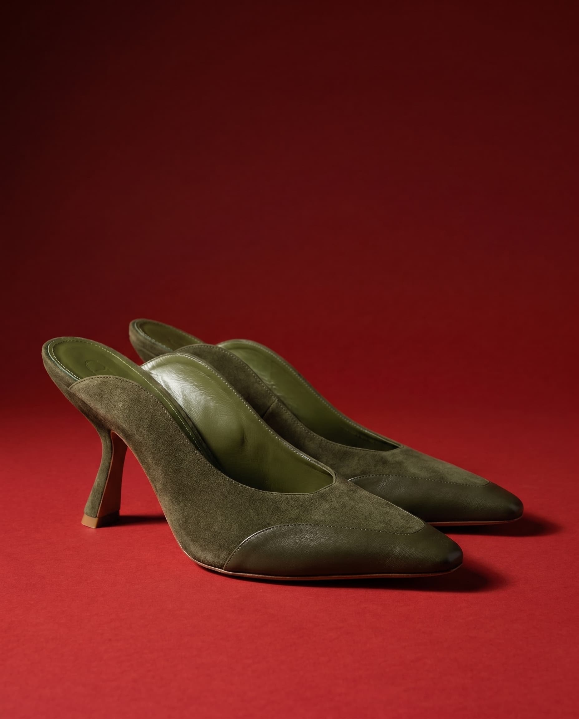 The Dianna — Szya green suede pumps on a cadmium-red ground